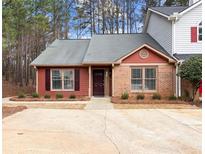 Charming single-story home with a well-maintained front yard, inviting entrance and neutral landscaping at 1310 Shiloh Nw Ter, Kennesaw, GA 30144