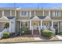 Charming townhouse with brick pathway leading to the front door and well manicured landscaping at 8 Alston Ne Pl, Atlanta, GA 30324