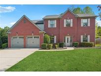 Charming two-story brick home with a well-manicured lawn and a two-car garage at 56 Ruth Way, Douglasville, GA 30134