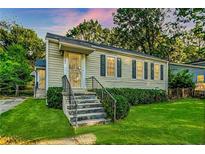 Charming single-story home featuring a well-manicured lawn, and inviting curb appeal at 1383 Almont Sw Dr, Atlanta, GA 30310