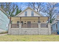 Charming renovated home featuring a covered front porch and stone foundation at 966 Ashby Grove Sw St, Atlanta, GA 30314