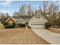 Charming single-story home with a well-manicured lawn and attached two-car garage at 1584 Snow Hill Dr, Lawrenceville, GA 30045