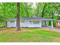 Charming one-story home with well-maintained lawn and a covered carport at 4973 White Blvd, Mableton, GA 30126