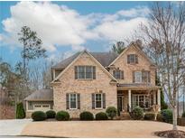 Charming two-story brick home with a well-manicured front yard and attached two car garage at 3621 Sutters Pond Way, Kennesaw, GA 30152