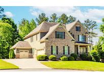 Charming brick home with manicured lawn and three car garage at 3621 Sutters Pond Way, Kennesaw, GA 30152