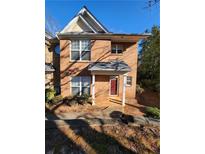 Brick townhome featuring multi-pane windows and a covered front porch at 3874 Austin Park Ln, Decatur, GA 30032