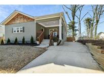 Charming one-story home with a welcoming front porch and a long driveway at 853 Gaston Sw St, Atlanta, GA 30310