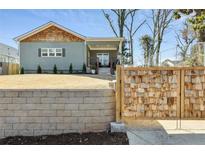 Charming craftsman home featuring a blend of brick and wood finishes, a covered front porch, and mature landscaping at 853 Gaston Sw St, Atlanta, GA 30310