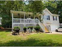 Charming two-story home featuring a covered porch, landscaped yard, and a fresh coat of exterior paint at 15 Winterville Dr, Rockmart, GA 30153