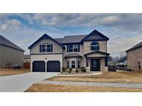 Beautiful two-story home with a brick and siding facade, two-car garage, and well-manicured lawn at 8103 White Oak Loop, Stone Mountain, GA 30038