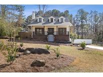 Charming two-story home featuring a welcoming front porch, landscaped yard, and a freshly painted exterior at 4596 Stewart Reilly Nw Dr, Acworth, GA 30101