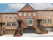Stunning brick townhome with multi-car garages and inviting entryway stairs at 873 Cedar River Se Ct, Marietta, GA 30067