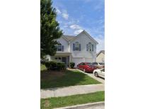 Charming two-story home with a manicured lawn and an attached two-car garage in a residential neighborhood at 1297 Quail Hunt Dr, Riverdale, GA 30296