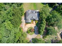 Stunning aerial view of a luxury home surrounded by lush landscaping and a circular driveway at 1603 Drowning Creek Rd, Dacula, GA 30019