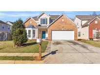 Charming two-story brick home with a well-manicured lawn and a two-car garage at 720 Goldenrod Way, Norcross, GA 30093