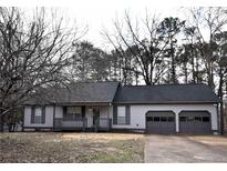 Charming ranch-style home with a two-car garage and a cozy front porch at 184 Brandywine Dr, Douglasville, GA 30134