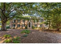 Charming brick home with a mature tree-lined yard and a traditional colonial-style entrance at 6700 Roswell Rd # 15B, Atlanta, GA 30328