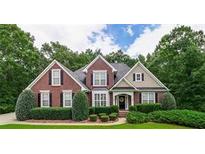 Charming two-story brick home with manicured landscaping, black shutters, and a welcoming front entrance at 2995 Barimore, Dacula, GA 30019