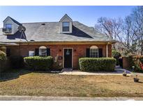 Charming brick townhouse with black shutters and a well-maintained front yard at 906 Little Bear Cove Ne, Conyers, GA 30012