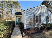 Charming single-story home with light blue siding, dark shutters, and a neatly landscaped front yard at 1395 W Booth Road Sw Ext, Marietta, GA 30008