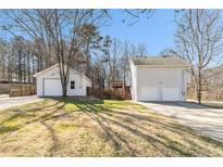 Two-story home features vinyl siding, two-car garage, a back deck, and driveway at 158 Ashwood Drive Dr, Dallas, GA 30157