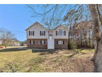 Charming two-story home featuring a brick foundation, symmetrical design, and inviting front steps at 158 Ashwood Drive Dr, Dallas, GA 30157