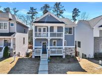 Charming two-story home featuring a double porch, light blue siding and a stone foundation at 5293 Hearthstone St, Stone Mountain, GA 30083