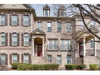 Charming brick townhome with a welcoming front porch and manicured landscaping at 1012 E Paces Chase Ne, Atlanta, GA 30326