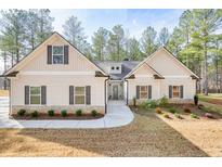 Charming single-Gathering home featuring stone accents and a welcoming front porch with a lovely front yard at 1312 Mcgarity Rd, Temple, GA 30179