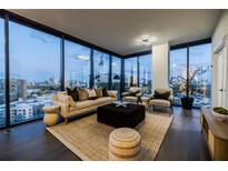 Modern living room featuring floor-to-ceiling windows and a comfortable seating arrangement with city views at 788 W Marietta Nw St # 1302, Atlanta, GA 30318