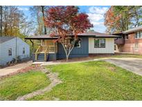 Charming renovated single-story home with mature tree and freshly landscaped front yard at 2873 Sylvan Rd, East Point, GA 30344