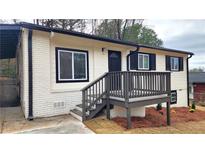 Charming home featuring a quaint front porch and a combination of brick and vinyl siding at 2232 Addison Nw Pl, Atlanta, GA 30318