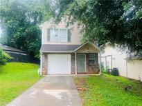 Charming two-story home with a one-car garage and a well-maintained lawn at 3523 Lehigh Way, Decatur, GA 30034