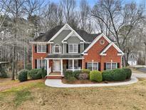 Charming two-story brick home with well-manicured landscaping and inviting curb appeal at 5712 Overlook Cir, Powder Springs, GA 30127