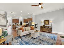 Inviting living room with hardwood floors, blue rug, and modern decor is great for entertaining or relaxation at 1583 Mosaic Way, Smyrna, GA 30080