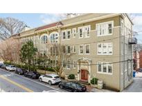 Charming multi-story condo building featuring a red tile roof and beautiful architectural details at 1116 Piedmont Ne Ave # 12, Atlanta, GA 30309