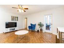 Bright living room featuring parquet floors, and access to a balcony with outside seating at 300 W Peachtree St # 8C, Atlanta, GA 30308