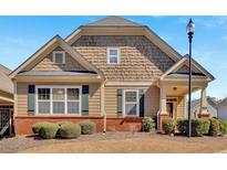 Charming single-Gathering home featuring a mix of traditional siding and shake accents, complemented by well-maintained landscaping at 343 Glens Way, Woodstock, GA 30188