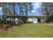 Charming single-story home with a well-maintained lawn and a convenient carport at 3680 Larkspur Ter, Decatur, GA 30032