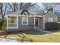 Charming single-story home with a covered front porch and well-maintained landscaping at 1600 Temple Ave, Atlanta, GA 30337