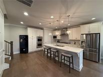 Modern kitchen featuring stainless steel appliances, a large island, and pendant lighting at 2021 Towneship Trl, Roswell, GA 30075