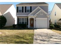 Charming two-story home with gray siding, black shutters, a well-manicured lawn and one-car garage at 1611 Heyford Nw Cir, Kennesaw, GA 30152