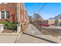 Brick apartment building showing the sidewalk, parking, and side of the building at 733 Frederica Ne St # 7, Atlanta, GA 30306