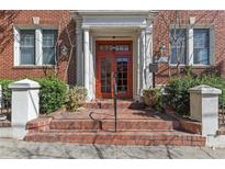 Charming brick building with a red door and brick steps leading to the entrance at 733 Frederica Ne St # 7, Atlanta, GA 30306