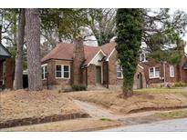Charming brick home featuring a gable roof and a well-maintained front yard at 1395 Winburn Dr, East Point, GA 30344
