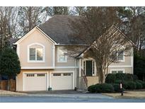 Charming two-story home with a well-manicured lawn, two-car garage, and lush landscaping at 2325 Woodcrest Se Dr, Smyrna, GA 30082