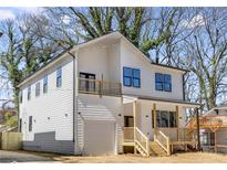 Charming two-story white home with a front porch and a second-story balcony at 61 Newcastle Sw St, Atlanta, GA 30314