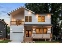 Charming two-story home featuring a covered porch and a second-story balcony for added outdoor enjoyment at 61 Newcastle Sw St, Atlanta, GA 30314