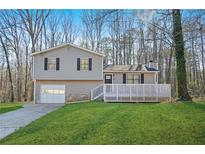 Charming split-level home featuring a large front yard and white lattice porch at 3730 N Quail Dr, Douglasville, GA 30135