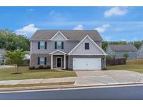 Charming two-story home with a well-manicured lawn and inviting curb appeal at 436 Vermeer Ct, Locust Grove, GA 30248